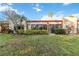Backyard featuring lush green grass, garden beds, and a tranquil atmosphere at 805 Spring Lakes Blvd # 805, Bradenton, FL 34210