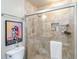 Bright bathroom features modern lighting, a walk-in shower with decorative tile, and a floating shelf at 805 Spring Lakes Blvd # 805, Bradenton, FL 34210