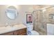 Bathroom featuring neutral tile in the glass enclosed shower, a wood vanity, and new fixtures at 805 Spring Lakes Blvd # 805, Bradenton, FL 34210