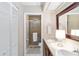 Bright bathroom with double sinks, wood cabinets, and tiled walk-in shower with glass door for a luxurious feel at 805 Spring Lakes Blvd # 805, Bradenton, FL 34210