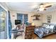 Comfortable bedroom with a ceiling fan, desk and a comfortable bed near sliding glass doors at 805 Spring Lakes Blvd # 805, Bradenton, FL 34210