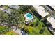 Aerial view of the community pool area featuring a sparkling pool, hot tub, and surrounding green space at 805 Spring Lakes Blvd # 805, Bradenton, FL 34210