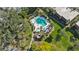 Overhead shot of the neighborhood pool, with a jacuzzi, lounging chairs, and a cozy seating area at 805 Spring Lakes Blvd # 805, Bradenton, FL 34210