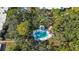 Aerial view of the community pool, situated among lush trees and offering a private and relaxing retreat for residents at 805 Spring Lakes Blvd # 805, Bradenton, FL 34210