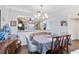 Elegant dining room with wood flooring, modern lighting, and a view into the kitchen at 805 Spring Lakes Blvd # 805, Bradenton, FL 34210