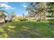 Expansive front yard showcasing lush green grass, mature trees, and beautiful landscaping at 805 Spring Lakes Blvd # 805, Bradenton, FL 34210