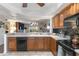 Open-concept kitchen featuring wood cabinets and views into living area at 805 Spring Lakes Blvd # 805, Bradenton, FL 34210