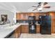 Updated kitchen with black appliances, sleek countertops, and wood cabinets at 805 Spring Lakes Blvd # 805, Bradenton, FL 34210
