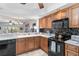 Updated kitchen with black appliances, sleek countertops, and wood cabinets at 805 Spring Lakes Blvd # 805, Bradenton, FL 34210