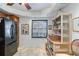 Well-lit kitchen featuring a black refrigerator and stylish wicker bookshelf at 805 Spring Lakes Blvd # 805, Bradenton, FL 34210