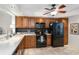 Well-lit kitchen featuring a black refrigerator, black appliances and tiled floor at 805 Spring Lakes Blvd # 805, Bradenton, FL 34210
