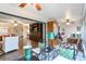 Open-concept living room with a ceiling fan, hardwood floors, and a variety of artwork for a vibrant space at 805 Spring Lakes Blvd # 805, Bradenton, FL 34210