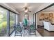 Cozy sunroom with a ceiling fan, floor to ceiling sliding glass windows, and comfortable seating for relaxation at 805 Spring Lakes Blvd # 805, Bradenton, FL 34210