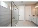 Modern bathroom with a glass-enclosed shower, tiled walls, and a vanity with storage at 8513 Golden Dawn Ct, Sarasota, FL 34241