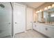 Modern bathroom featuring a double sink vanity, large mirror and a glass enclosed shower at 8513 Golden Dawn Ct, Sarasota, FL 34241