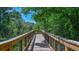Elevated wooden boardwalk winds through a lush, green natural preserve at 8513 Golden Dawn Ct, Sarasota, FL 34241