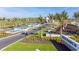 Community entrance showcases palm trees, landscaping, decorative water feature, and community signage at 8513 Golden Dawn Ct, Sarasota, FL 34241