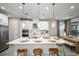 Modern kitchen features white cabinets, stainless appliances, and island with seating at 8513 Golden Dawn Ct, Sarasota, FL 34241