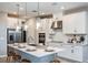 Modern kitchen features white cabinets, stainless steel appliances, and large island at 8513 Golden Dawn Ct, Sarasota, FL 34241