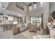 Open-concept living room with a kitchen view, high ceilings, and modern furnishings at 8513 Golden Dawn Ct, Sarasota, FL 34241