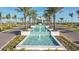 Entrance to the community with tiered water feature, manicured landscaping, and palm trees at 8513 Golden Dawn Ct, Sarasota, FL 34241