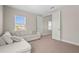 Neutral bedroom featuring a comfortable sofa and a view of a connecting room at 8609 Evening Dr, Sarasota, FL 34241