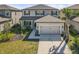 Charming two-story home with a two-car garage, manicured lawn and tropical landscaping at 8609 Evening Dr, Sarasota, FL 34241