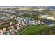 Panoramic aerial view of the neighborhood showcasing lush golf courses and scenic lakes at 8717 54Th E Ave, Bradenton, FL 34211