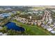 Picturesque aerial view of a neighborhood nestled between a serene lake and a sprawling golf course at 8717 54Th E Ave, Bradenton, FL 34211