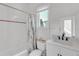 A clean, well-lit bathroom with a shower-tub combo and modern vanity at 8717 54Th E Ave, Bradenton, FL 34211