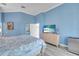 Cozy bedroom with a beach-themed TV screen, light blue walls, and modern furnishings at 8717 54Th E Ave, Bradenton, FL 34211