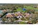 View of the clubhouse, golf course and tennis courts, all nestled among mature landscaping and trees at 8717 54Th E Ave, Bradenton, FL 34211