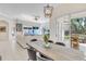 Well-lit dining room adjacent to a living area with an outdoor patio view at 8717 54Th E Ave, Bradenton, FL 34211