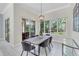 Well-lit dining room with a wooden table, stylish seating, and bright views of outdoor greenery at 8717 54Th E Ave, Bradenton, FL 34211