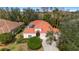 Exterior of home showing the well-manicured lawn, trees, and a two-car garage at 8717 54Th E Ave, Bradenton, FL 34211