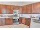 Modern kitchen featuring stainless steel appliances, wood cabinetry, and white backsplash at 8717 54Th E Ave, Bradenton, FL 34211