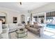 Bright living room featuring modern sofas, a glass coffee table, and access to an outdoor pool area at 8717 54Th E Ave, Bradenton, FL 34211