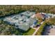 Aerial view of tennis courts alongside a refreshing pool, creating an active and vibrant community at 8717 54Th E Ave, Bradenton, FL 34211