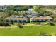 Scenic aerial view of multi-Gathering buildings on golf course with lake and mature trees surrounding the community at 8735 Olde Hickory Ave # 8210, Sarasota, FL 34238
