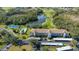 An aerial view showcasing community amenities, including a pool, tennis court, parking and lake at 8735 Olde Hickory Ave # 8210, Sarasota, FL 34238