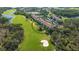 Aerial view of golf course community surrounded by lush greenery and lakes at 8735 Olde Hickory Ave # 8210, Sarasota, FL 34238