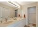 Bathroom with a double sink vanity, neutral tile, and walk-in shower at 8735 Olde Hickory Ave # 8210, Sarasota, FL 34238