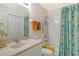 Bathroom featuring a shower-tub combo and a patterned shower curtain at 8735 Olde Hickory Ave # 8210, Sarasota, FL 34238