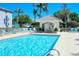 An inviting community pool with lounge chairs and a gazebo-style structure at 8735 Olde Hickory Ave # 8210, Sarasota, FL 34238