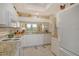 Bright kitchen with white cabinets, granite counters, and a cozy breakfast bar at 8735 Olde Hickory Ave # 8210, Sarasota, FL 34238