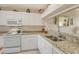 Kitchen featuring white cabinetry, granite countertops, and modern appliances at 8735 Olde Hickory Ave # 8210, Sarasota, FL 34238