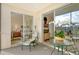 Inviting lanai, offering views of living room, bedroom, and the golf course at 8735 Olde Hickory Ave # 8210, Sarasota, FL 34238
