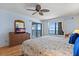 Spacious bedroom featuring a ceiling fan, balcony access, and gorgeous ocean views at 900 Gulf Blvd # 805, Indian Rocks Beach, FL 33785