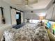 Relaxing bedroom showcasing neutral tones, a ceiling fan, and barn door to the closet at 10315 Cortez W Rd # 12-3, Bradenton, FL 34210