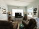 Comfortable living room with a TV and a showcase of nautical decorations on the wall at 10315 Cortez W Rd # 12-3, Bradenton, FL 34210